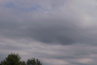 Clouds 1, own work. Depicts a dark, sprawling cloud cover over a few trees.